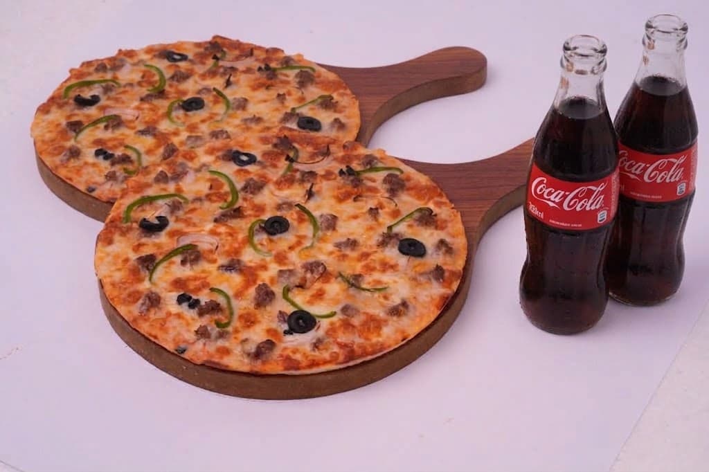 Two small pizzas with two bottled drinks